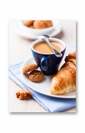 Cup of espresso with biscotti and croissant