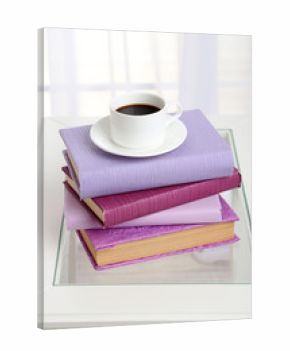 Purple books with cup near sofa