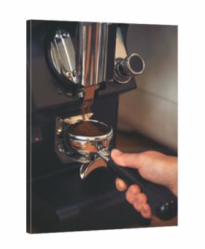 Coffee grinder grinds freshly coffee beans in a portafilter