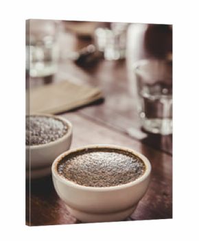 coffee grounds with hot water in the ceramic cup on the table is preparing for professional Q Grader to testing and inspecting the quality of coffee.