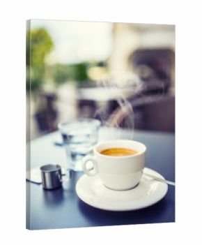 Cup of coffee on table in restaurant terrace
