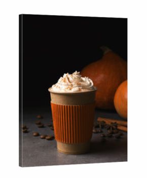 Paper cup with tasty pumpkin spice latte on gray table