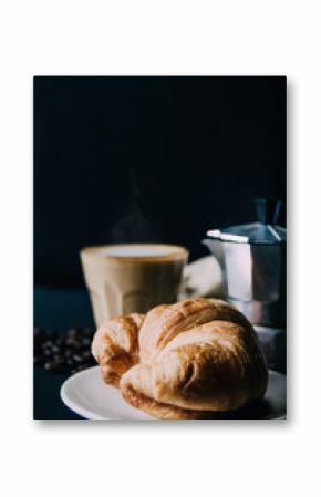 Croissant ,Latte art ,and moka pot with Roasted coffee on black background in the morning and instagram style filter photo vintage tone