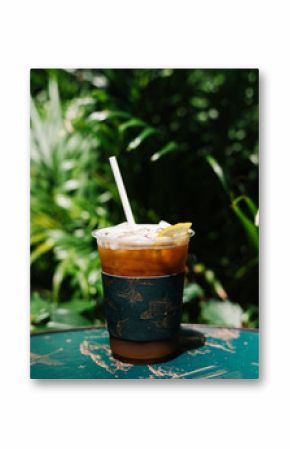 Iced cold brew coffee with lemon on a table
