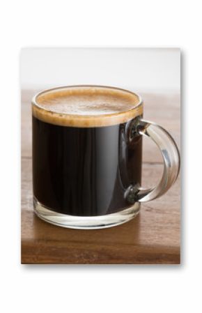 Black coffee and froth in glass mug wood table