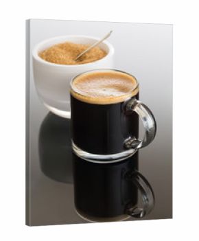 Black coffee and froth in glass mug with sugar