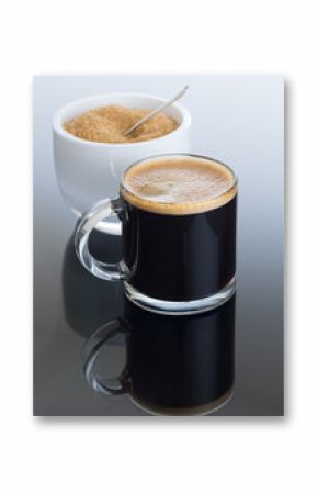 Black coffee and froth in glass mug with sugar