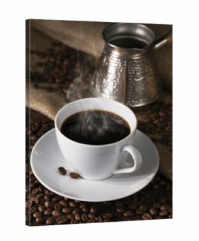 Fuming cup of coffee, coffee maker and coffee grains round them