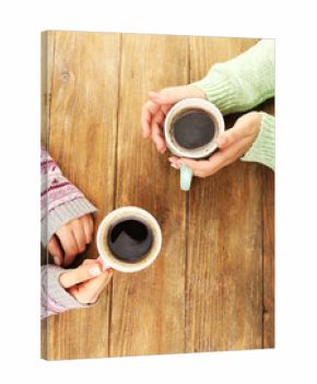 Female hands holding cups of coffee