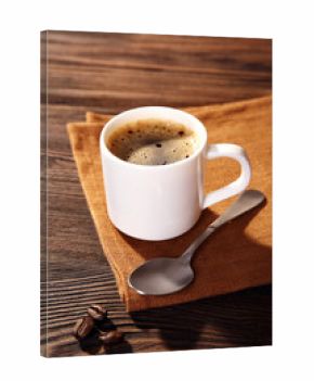 Cup of coffee on napkin on table close up