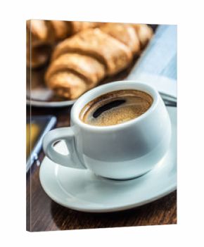 Coffee break business. Cup of coffee mobile phone croissants and newspaper.