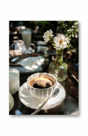A cup of Black Coffee placed on glass table