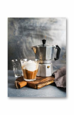 Glass of coffee with ice cream on rustic wooden board and steel Italian Moka pot