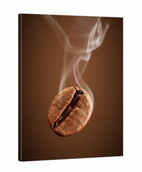 Closeup falling coffee bean with smoke on brown background