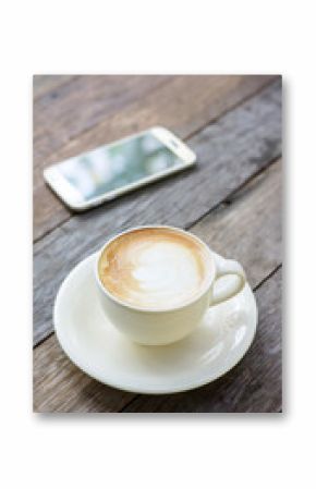 Hot coffee and smartphone on a wooden table.