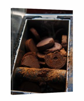 Closeup shot of used hot coffee grounds from espresso machine maker. Pressed coffee tablets in trash garbage bin. Toned with film filters.