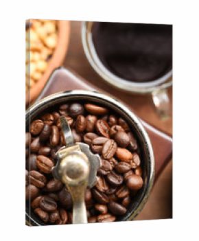 cup of coffee and coffee beans in coffee grinder for background