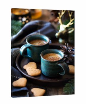 Cozy table setting with two cups of espresso coffee served with heart shaped cookies