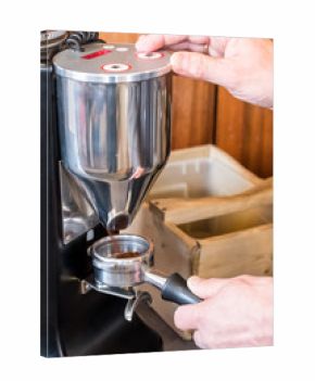 Barista grinding coffee beans with grinder to making espresso coffee