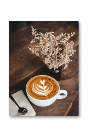 Cup of hot latte art coffee on wooden table