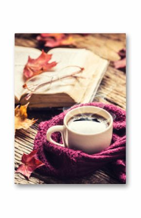 Cup of coffee old  book glasses and autumn leaves.