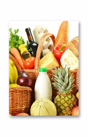 Groceries in wicker basket isolated on white