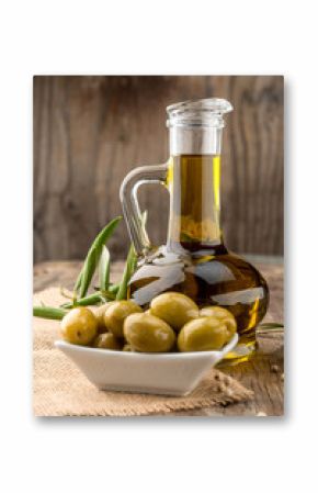 Olive oil and olive branch on the wooden table