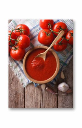 tomato sauce with garlic and basil in a bowl. vertical top view  