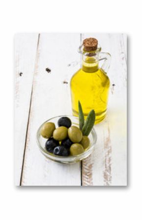 Virgin olive oil in a crystal bottle on white wooden table  