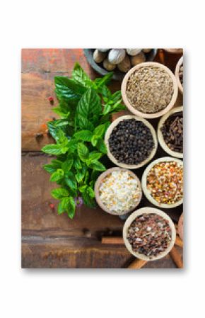 Variety of different asian and middle east spices, colorful assortment, on old wooden table top view