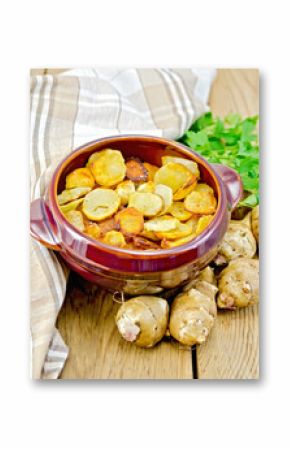 Jerusalem artichokes fried in a pan on the board