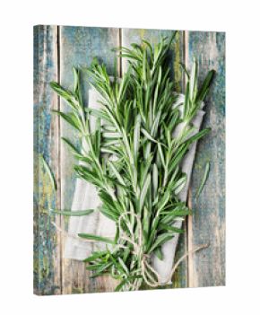Bunch of rosemary on wooden table, rustic style, fresh organic herbs, top view