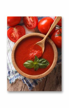 Fresh tomato sauce in a wooden bowl closeup. vertical top view  