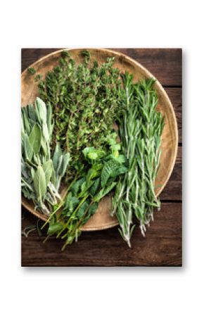 various fresh herbs, rosemary, thyme, mint and sage on wooden background