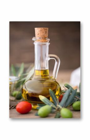 healthy olive oil and olive branch on the wooden table.