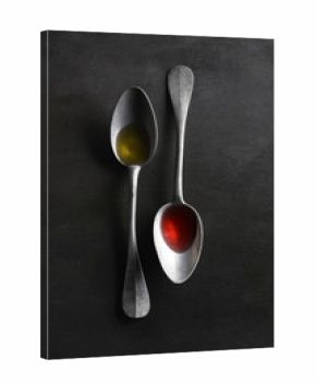 Overhead view of oil and vinegar in spoons