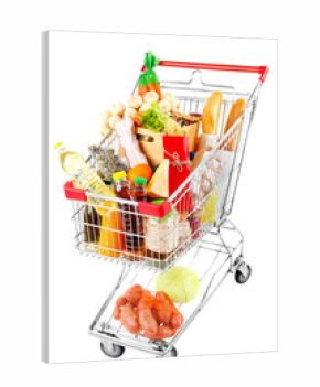 Shopping cart full with various groceries isolated on white