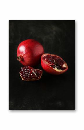 Delicious pomegranate fruit on black background