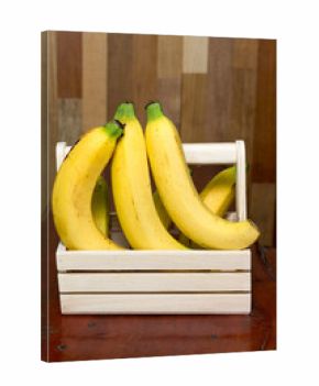 bananas in the basket on wooden table.