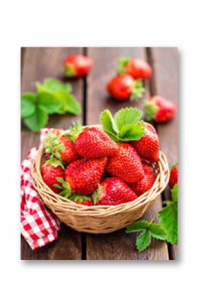Fresh strawberry in basket on wooden rustic table, closeup. Delicious, juicy, red  berries. Healthy eating.