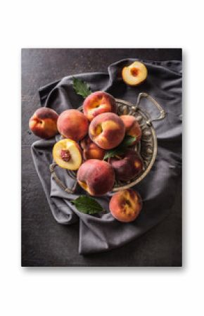 A group a ripe peaches in rustic bowl