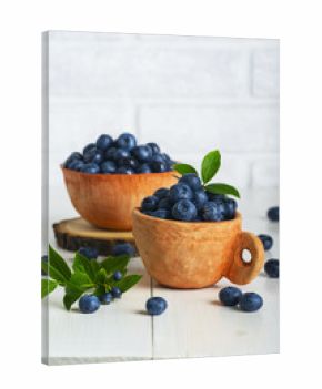 Blueberries with leaves in a clay cup