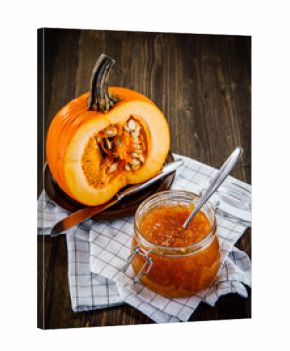 Pumpkin with jam on wooden background
