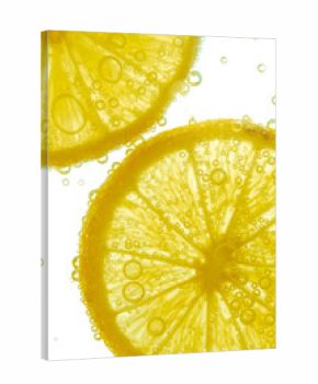 Fresh lemon slice in water with bubbles on white background