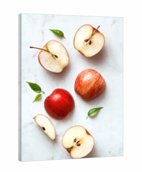 Apples flat lay on a marble background. Group of sliced and whole apple fruits viewed from above. Top view