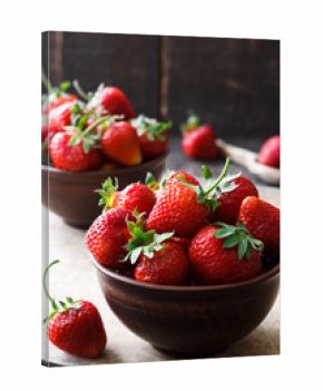Fresh strawberry in a bowl on a wooden background