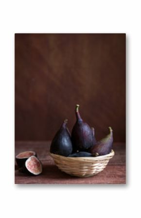 Whole figs and one fig sliced in half on the table. Organic food for healthy life