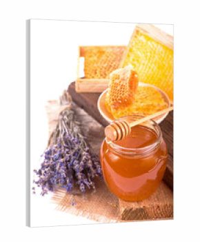 glass pot with floral honey and a bouquet of lavender isolated on white background