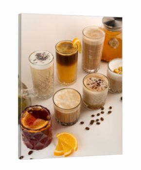 A row of autumn-themed drinks, featuring mulled wine, popcorn latte, and lavender coffee on a light backdrop