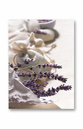 Hand made lavender sachets in textile bags and cotton hearts on cotton background. Low impact natural lifestyle. Bunch of dry lavender, close-up. Dry lavender flowers in wrapping paper.